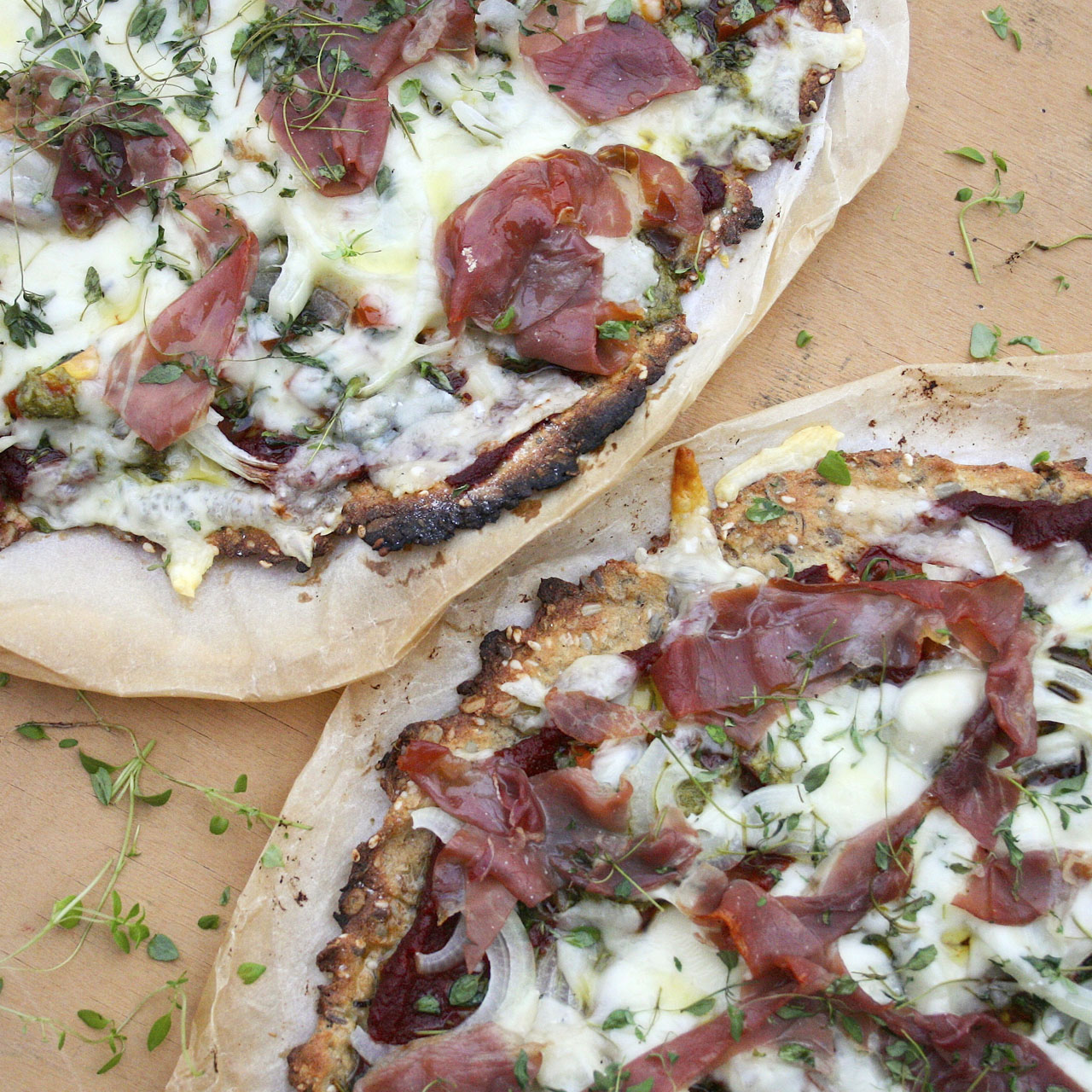 Simple pizza with parma ham, herbs and gluten-free base